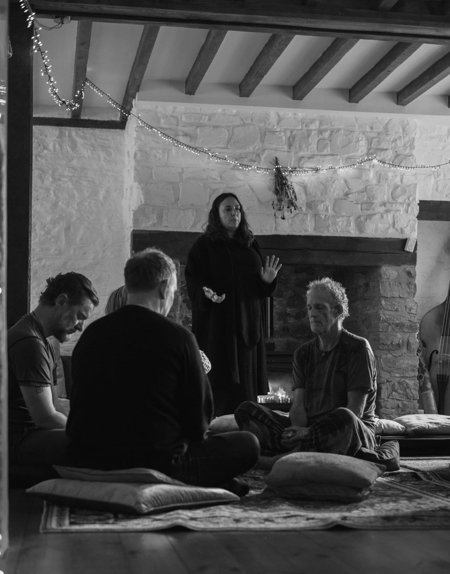 The circle seated in silence as a facilitator speaks