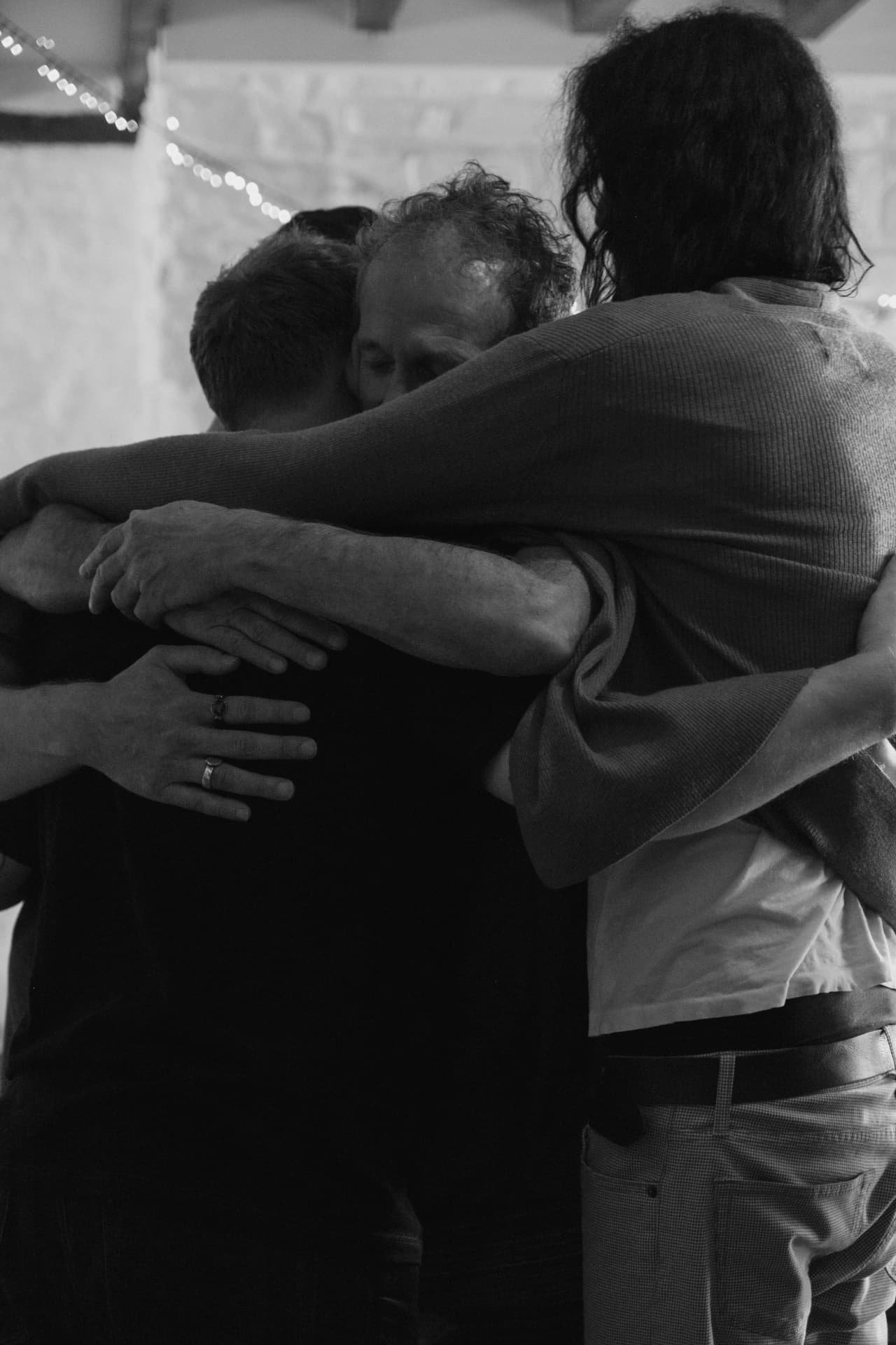 Participants in a close group embrace